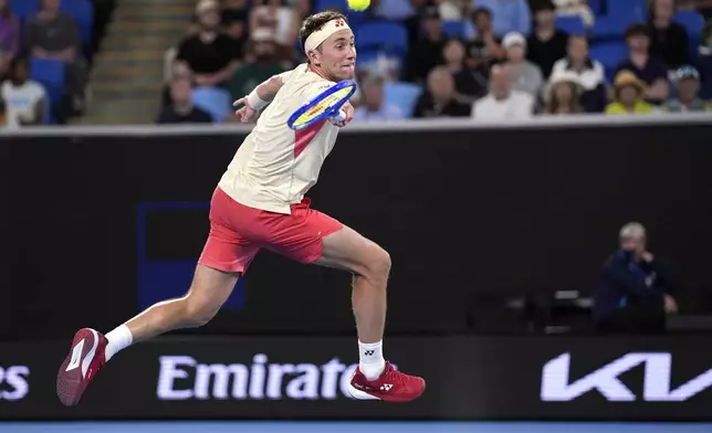 Casper Ruud of Norway plays a forehand return to Jakub Mensik of the Czech Republic during their second round match at the Australian Open tennis championship in Melbourne, Australia, Wednesday, Jan. 15, 2025. (AP Photo/Ng Han Guan)