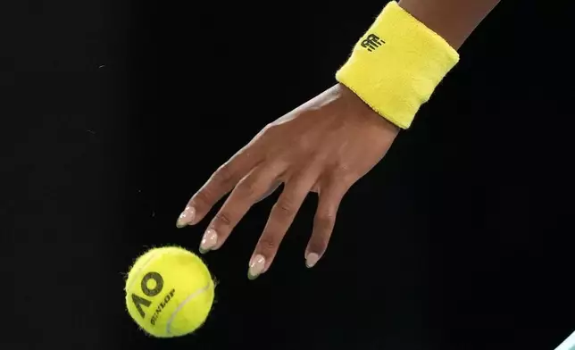 Coco Gauff of the U.S. prepares to serve to Jodie Burrage of Britain during their second round match at the Australian Open tennis championship in Melbourne, Australia, Wednesday, Jan. 15, 2025. (AP Photo/Manish Swarup)