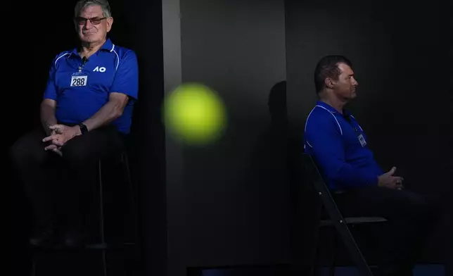 Security sit watch on Rod Laver Arena as Jannik Sinner of Italy plays Tristan Schoolkate of Australia in a second round match at the Australian Open tennis championship in Melbourne, Australia, Thursday, Jan. 16, 2025. (AP Photo/Asanka Brendon Ratnayake)