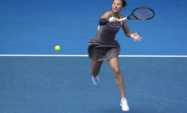 Zheng Qinwen of China plays a forehand return to Laura Siegemund of Germany during their second round match at the Australian Open tennis championship in Melbourne, Australia, Wednesday, Jan. 15, 2025. (AP Photo/Asanka Brendon Ratnayake)