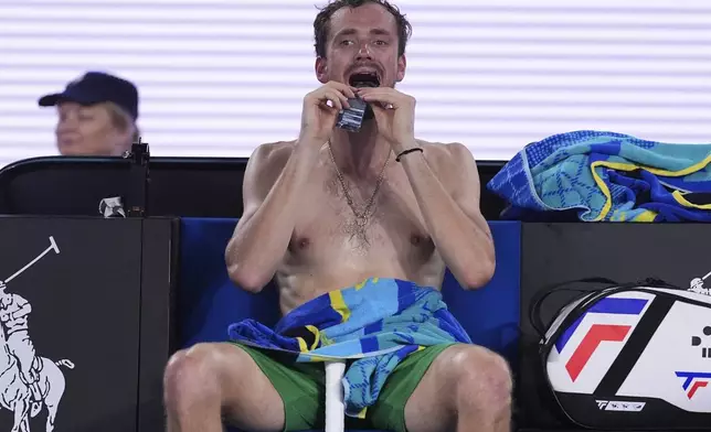Daniil Medvedev of Russia eats food during a break in his second round match against Learner Tien of the U.S. at the Australian Open tennis championship in Melbourne, Australia, Thursday, Jan. 16, 2025. (AP Photo/Ng Han Guan)