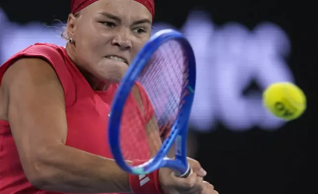 Diana Shnaider of Russia plays a backhand return to Ajla Tomljanovic of Australia during their second round match at the Australian Open tennis championship in Melbourne, Australia, Wednesday, Jan. 15, 2025. (AP Photo/Asanka Brendon Ratnayake)