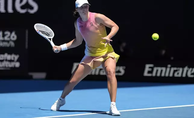 Iga Swiatek of Poland plays a forehand return to Rebecca Sramkova of Slovakia during their second round match at the Australian Open tennis championship in Melbourne, Australia, Thursday, Jan. 16, 2025. (AP Photo/Asanka Brendon Ratnayake)