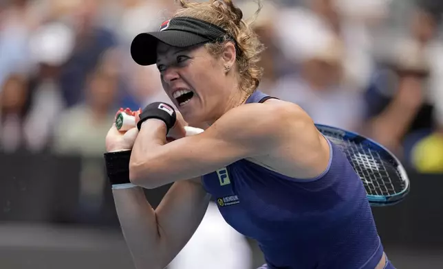 Laura Siegemund of Germany plays a backhand return to Zheng Qinwen of China during their second round match at the Australian Open tennis championship in Melbourne, Australia, Wednesday, Jan. 15, 2025. (AP Photo/Asanka Brendon Ratnayake)