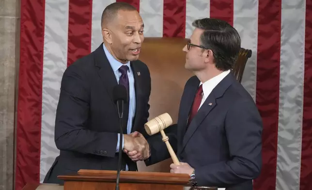 House Minority Leader Hakeem Jeffries, D-N.Y., left, shakes hands after giving the gavel to House Speaker Mike Johnson, R-La., in a customary nod to the peaceful transfer of power as the House of Representatives meets to elect a speaker and convene the new 119th Congress at the Capitol in Washington, Friday, Jan. 3, 2025. (AP Photo/Jacquelyn Martin)