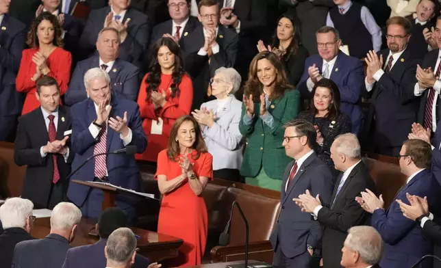 Rep. Lisa McClain, R-Mich., center left, and others applaud House Speaker Mike Johnson, R-La., as the House of Representatives meets to elect a speaker and convene the new 119th Congress at the Capitol in Washington, Friday, Jan. 3, 2025. (AP Photo/Mark Schiefelbein)