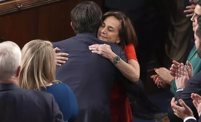 Rep. Lisa McClain, R-Mich., right, congratulates House Speaker Mike Johnson, R-La., upon Johnson's re-election as the House of Representatives meets to elect a speaker and convene the new 119th Congress at the Capitol in Washington, Friday, Jan. 3, 2025. (AP Photo/Jacquelyn Martin)