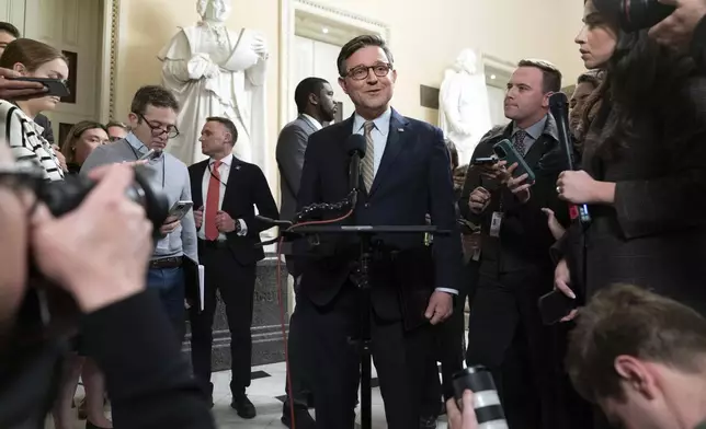 Speaker of the House Mike Johnson, R-La., talks to reporters after the House approved a funding bill to avert the government shutdown, at the Capitol in Washington, Friday, Dec. 20, 2024. (AP Photo/Jose Luis Magana)