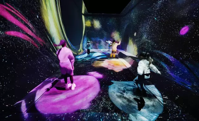 teamLab, Multi Jumping Universe (c) teamLab - Multi Jumping is a flexible surface that people can jump on, and sink or jump higher than usual. When you stand on Multi Jumping, the surface beneath your feet sinks, creating warps in space and time. This distortion attracts stardust from the universe and births new stars. If you jump on top of a star, it begins to move, and if you continue to jump on the star it will grow and you will be able to experience the entire life cycle of the star.