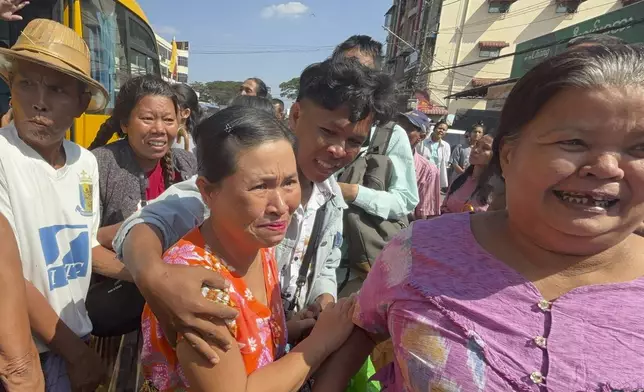 Released prisoners, front center and right, are welcomed by family members and colleagues outside Insein Prison Saturday, Jan. 4, 2025, in Yangon, Myanmar, as the military government has released more than 6,000 prisoners and has reduced other inmates’ sentences as part of a mass amnesty to mark the 77th anniversary of independence from Britain. (AP Photo/Thein Zaw)