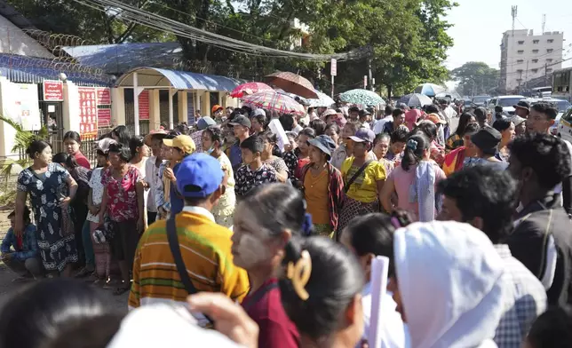 Family members wait to welcome released prisoners from Insein Prison Saturday, Jan. 4, 2025, in Yangon, Myanmar, as the military government has released more than 6,000 prisoners and has reduced other inmates’ sentences as part of a mass amnesty to mark the 77th anniversary of independence from Britain. (AP Photo/Thein Zaw)