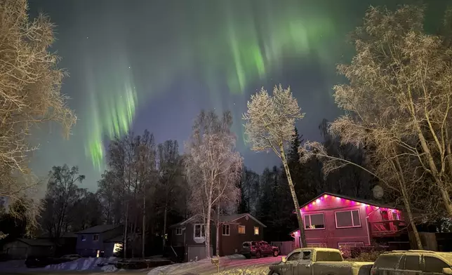 The northern lights appear over homes in Anchorage, Alaska, on Wednesday, Jan. 1, 2025. (AP Photo/Mark Thiessen)