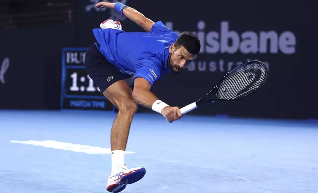 Serbia's Novak Djokovic plays a shot to USA's Reilly Opelka during their match at the Brisbane International, in Brisbane, Australia, Friday, Jan. 3, 2025. (AP Photo/Pat Hoelscher)