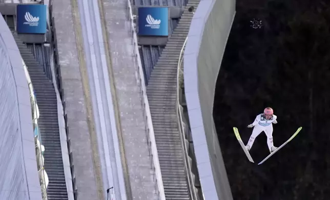 Stefan Kraft, of Austria, soars through the air during his second round jump at the second stage of the 73rd Four Hills ski jumping tournament in Garmisch-Partenkirchen, Germany, Wednesday, Jan. 1, 2025. (AP Photo/Matthias Schrader)