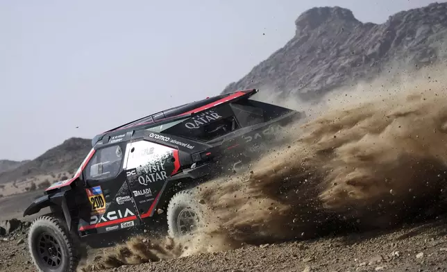 Driver Nasser Al-Attiyah and co-driver Edouard Boulanger competes during the prologue of the Dakar Rally in Bisha, Saudi Arabia, Friday, Jan. 3, 2025. (AP Photo/Christophe Ena)