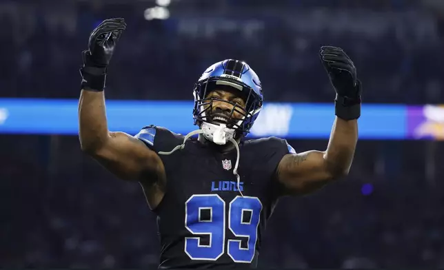 Detroit Lions defensive end Za'Darius Smith (99) celebrates after he sacked Minnesota Vikings quarterback Sam Darnold during the first half of an NFL football game Sunday, Jan. 5, 2025, in Detroit. (AP Photo/Rey Del Rio)