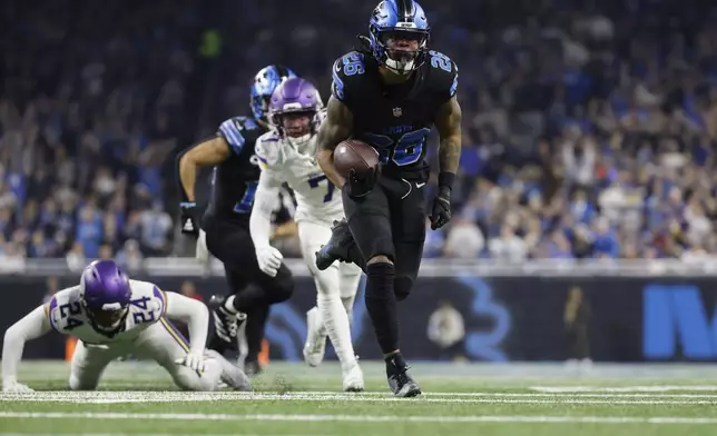 Detroit Lions running back Jahmyr Gibbs (26) runs for a touchdown against the Minnesota Vikings during the first half of an NFL football game Sunday, Jan. 5, 2025, in Detroit. (AP Photo/Rey Del Rio)