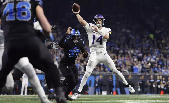 Minnesota Vikings quarterback Sam Darnold (14) throws against the Detroit Lions during the first half of an NFL football game Sunday, Jan. 5, 2025, in Detroit. (AP Photo/Rey Del Rio)