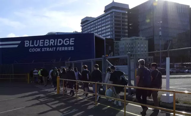 Bluebridge ferry passengers disembark in Wellington, New Zealand, on Tuesday, Jan. 7, 2025. (AP Photo/Charlotte Graham-McLay)