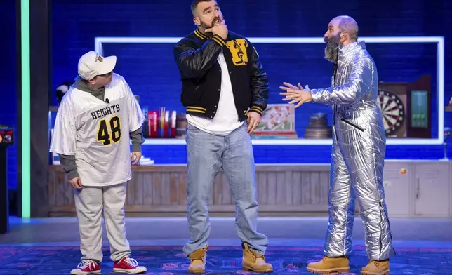 Former NFL player and ESPN analyst Jason Kelce, center, performs a skit with a younger and older version of himself during the taping of "They Call It Late Night with Jason Kelce", Friday, Jan. 3, 2025, in Philadelphia. (AP Photo/Chris Szagola)