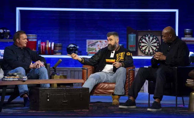 Former NFL player and ESPN analyst Jason Kelce, centert, talks with his guest, former NFL player Brian Baldinger, left and NBA Hall of Famer Charlies Barkley, right, during the taping of "They Call It Late Night with Jason Kelce", Friday, Jan. 3, 2025, in Philadelphia. (AP Photo/Chris Szagola)