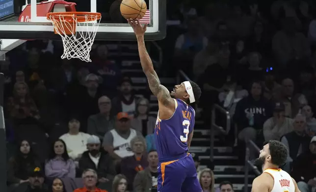 Phoenix Suns guard Bradley Beal (3) drives past Atlanta Hawks forward David Roddy score during the first half of an NBA basketball game Thursday, Jan. 9, 2025, in Phoenix. (AP Photo/Ross D. Franklin)z