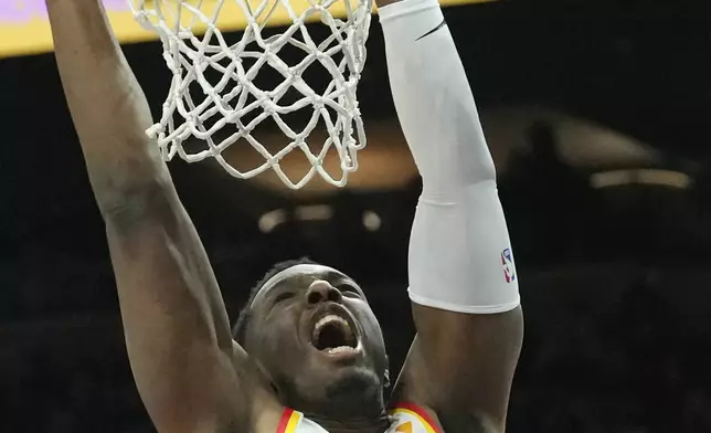 Atlanta Hawks forward Onyeka Okongwu dunks against the Phoenix Suns during the first half of an NBA basketball game Thursday, Jan. 9, 2025, in Phoenix. (AP Photo/Ross D. Franklin)