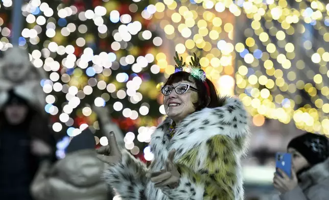 People gather in the center of the Russian far east port of Vladivostok, Russia, Tuesday, Dec. 31, 2024, to celebrate the new year. (AP Photo)