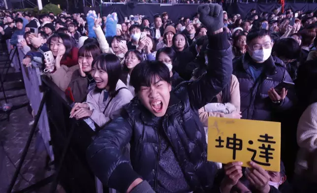 People cheer during the 2025 Taipei New Year's Party celebration in front of the Taipei City Government Building in Taipei, Taiwan, Tuesday, Dec. 31, 2024. (AP Photo/Chiang Ying-ying)