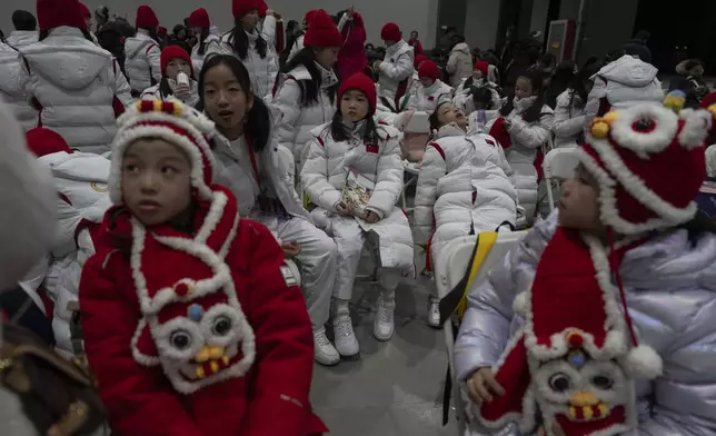 Young performers wait backstage for a count down event held in Beijing, Tuesday, Dec. 31, 2024. (AP Photo/Ng Han Guan)