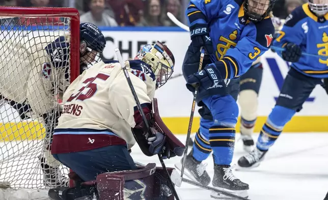 Montreal Victoire goaltender Ann-Renee Desbiens (35) stops Toronto Sceptres' Hannah Miller (34) during the second period of PWHL hockey game in Vancouver, on Wednesday, Jan. 8, 2025. (Ethan Cairns/The Canadian Press via AP)