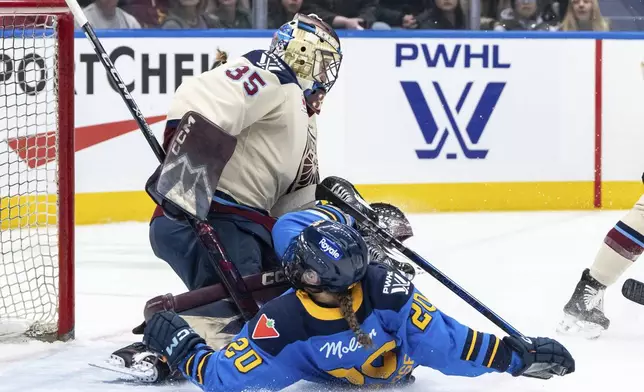 Toronto Sceptres' Sarah Nurse (20) slides into Montreal Victoire goaltender Ann-Renee Desbiens (35) during second period PWHL hockey action in Vancouver, on Wednesday, January 8, 2025. (Ethan Cairns/The Canadian Press via AP)