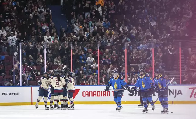 Montreal Victoire's Marie-Philip Poulin, left, celebrates her goal with teammates as the Toronto Sceptres skate back to the bench during second period PWHL hockey action in Vancouver, on Wednesday, January 8, 2025. (Ethan Cairns/The Canadian Press via AP)