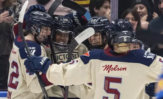 Montreal Victoire's Mikyla Grant-Mentis (18) celebrates her goal against the Toronto Sceptres with teammates during first period PWHL hockey action in Vancouver, on Wednesday, January 8, 2025. (Ethan Cairns/The Canadian Press via AP)