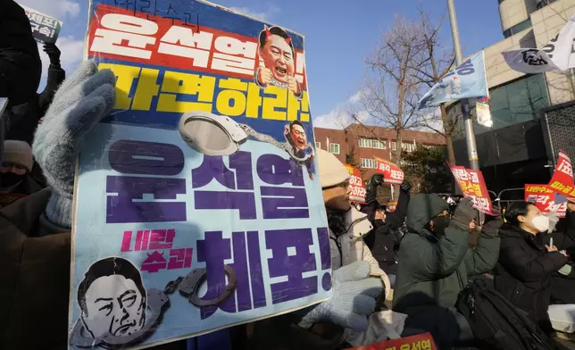 Protesters attend a rally demanding the arrest of impeached South Korean President Yoon Suk Yeol near the presidential residence in Seoul, South Korea, Wednesday, Jan. 8, 2025. The letters read, "Arrest Yoon Suk Yeol." (AP Photo/Ahn Young-joon)