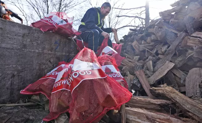 Phillip Stanford prepares firewood for sale ahead of a winter storm expected to hit the North Texas region later tomorrow Wednesday, Jan. 8, 2025, in Dallas. (AP Photo/LM Otero)