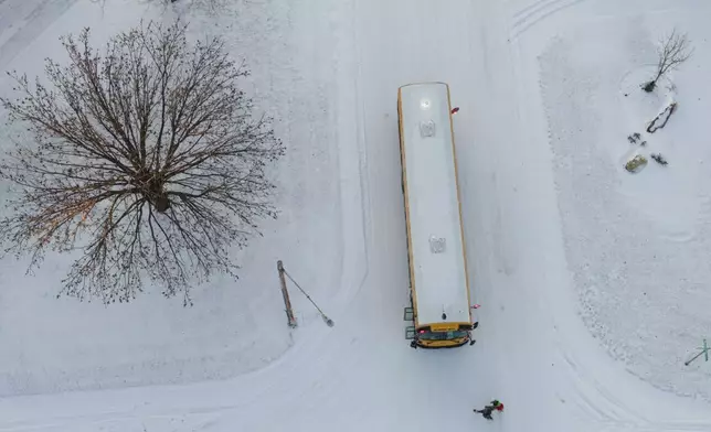 Students board a USD265 school bus on Wednesday, Jan. 8, 2025 in Wichita, Kan. (Jaime Green/The Wichita Eagle via AP)