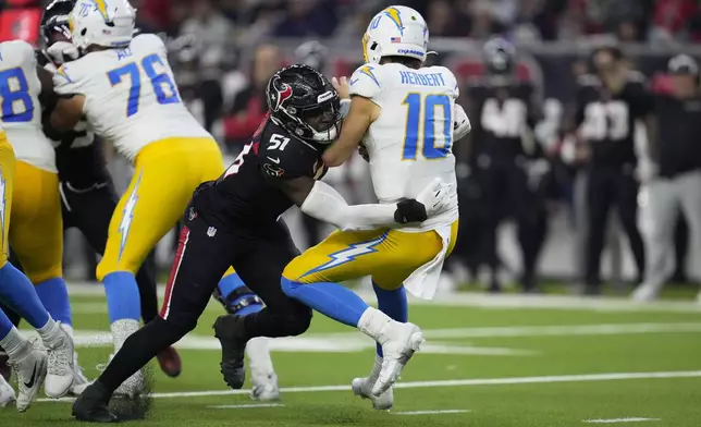 Los Angeles Chargers quarterback Justin Herbert (10) is sacked by Houston Texans' Will Anderson Jr. (51) during the second half of an NFL wild-card playoff football game Saturday, Jan. 11, 2025, in Houston. (AP Photo/Ashely Landis)