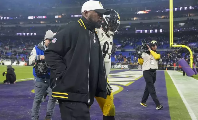 Pittsburgh Steelers head coach Mike Tomlin, center, walks off the field with defensive tackle Cameron Heyward (97) following an NFL wild-card playoff football game against the Baltimore Ravens, Saturday, Jan. 11, 2025, in Baltimore. The Ravens won 28-14. (AP Photo/Stephanie Scarbrough)