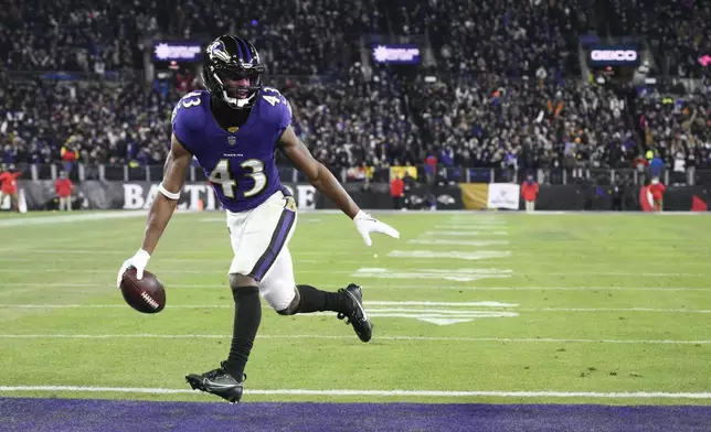Baltimore Ravens running back Justice Hill scores on a pass from quarterback Lamar Jackson during the first half of an NFL wild-card playoff football game against the Pittsburgh Steelers, Saturday, Jan. 11, 2025, in Baltimore. (AP Photo/Nick Wass)