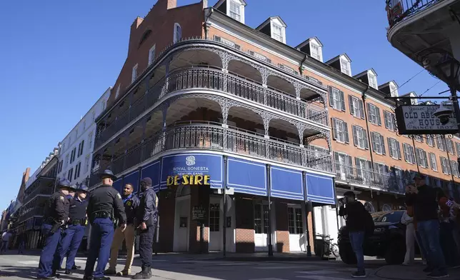 Law enforcement gather in front of the Sonesta Hotel on Bourbon Street, Thursday, Jan. 2, 2025 in New Orleans. (AP Photo/George Walker IV)