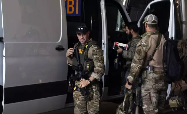 FBI personnel arrive at the Caesars Superdome ahead of the Sugar Bowl NCAA College Football Playoff game, Thursday, Jan. 2, 2025, in New Orleans. (AP Photo/Butch Dill)