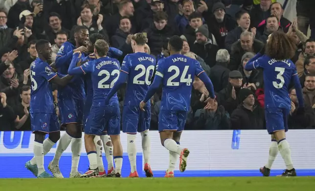 Chelsea's Tosin Adarabioyo celebrates with teammates after scoring his side's opening goal during the English Premier League soccer match between Chelsea and Wolverhampton at Stamford Bridge stadium in London, Monday, Jan. 20, 2025. (AP Photo/Kin Cheung)