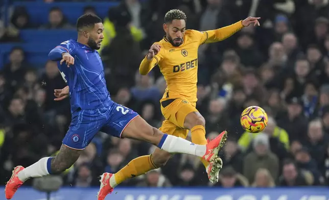 Chelsea's Reece James, left, duels for the ball with Wolverhampton Wanderers' Matheus Cunha during the English Premier League soccer match between Chelsea and Wolverhampton at Stamford Bridge stadium in London, Monday, Jan. 20, 2025. (AP Photo/Kin Cheung)