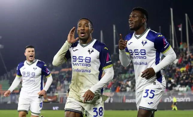 Verona's Jackson Tchatchoua, center, celebrates after scoring his side's first goal during the Serie A soccer match between Venezia and Hellas Verona in Venice, Italy, Monday, Jan. 27, 20245. (Paola Garbuio/LaPresse via AP)