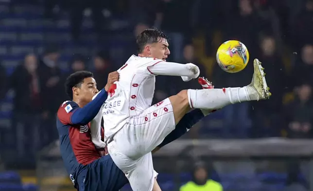 Genoa's Koni De Winter jumps for the ball with Monza's Daniel Maldini, right, during the Serie A soccer match between Genoa and Monza at the Luigi Ferraris Stadium in Genoa, Italy, Monday, Jan. 27, 2025. (Tano Pecoraro/LaPresse via AP)