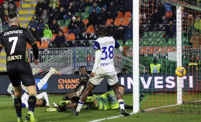 Verona's Jackson Tchatchoua, centre, scores his side's first goal during the Serie A soccer match between Venezia and Hellas Verona at the Pier Luigi Penzo Stadium in Venice, Italy, Monday, Jan. 27, 2025. (Paola Garbuio/LaPresse via AP)