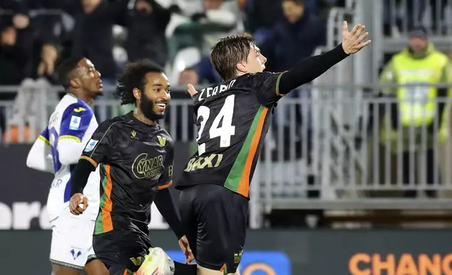 Venezia's Alessio Zerbin, front, celebrates after scoring the opening goal during the Serie A soccer match between Venezia and Hellas Verona in Venice, Italy, Monday, Jan. 27, 20245. (Paola Garbuio/LaPresse via AP)