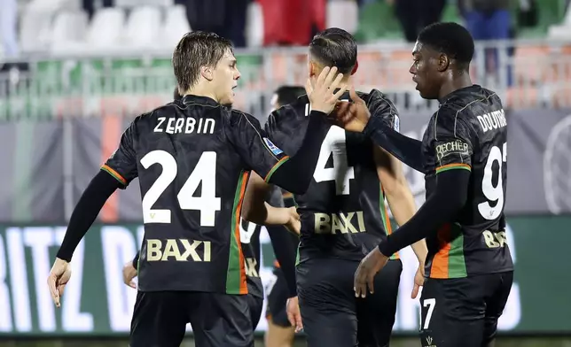 Venezia's Alessio Zerbin, left, celebrates after scoring the opening goal during the Serie A soccer match between Venezia and Hellas Verona in Venice, Italy, Monday, Jan. 27, 20245. (Paola Garbuio/LaPresse via AP)