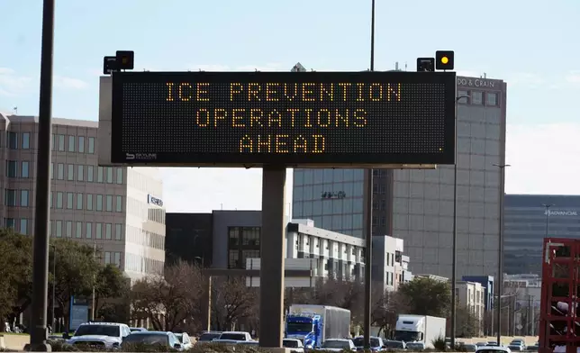 A sign warns drivers of ice prevention operations ahead of a winter storm expected to hit the North Texas region later this week, Tuesday, Jan. 7, 2025, in Dallas. (AP Photo/LM Otero)